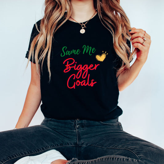 A stylish woman wearing a black t-shirt with a slogan that says - "Same Me, Bigger Goals"